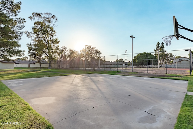 view of basketball court with a yard