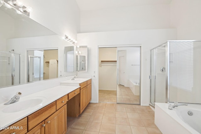 bathroom featuring plus walk in shower, vanity, and tile patterned floors