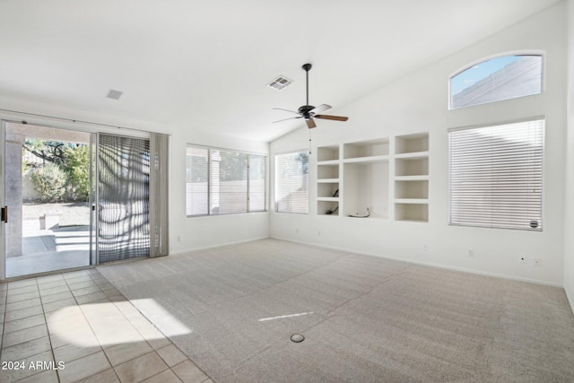 tiled empty room featuring ceiling fan, built in features, and lofted ceiling