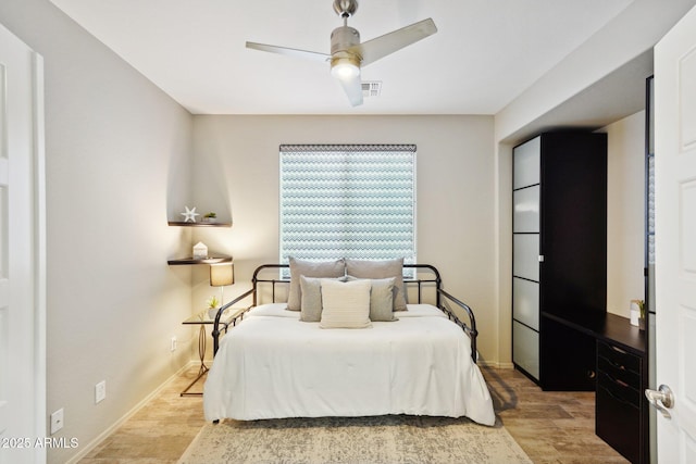 bedroom with ceiling fan and light wood-type flooring