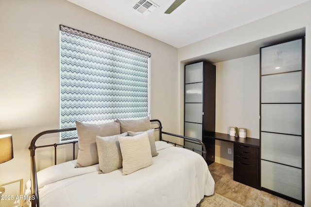 bedroom with ceiling fan and light hardwood / wood-style floors