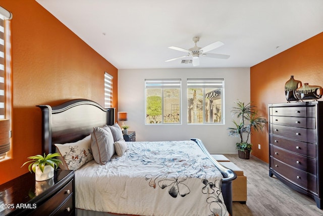 bedroom with ceiling fan and light hardwood / wood-style floors