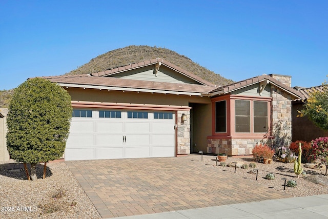 view of front of house with a garage and a mountain view