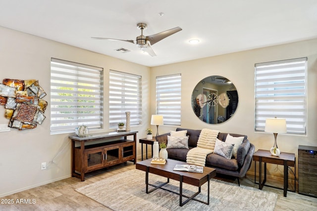 living room featuring ceiling fan and plenty of natural light