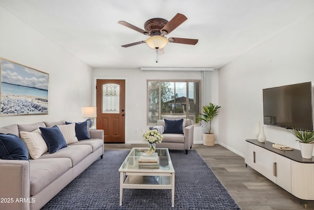 living room with dark hardwood / wood-style floors and ceiling fan