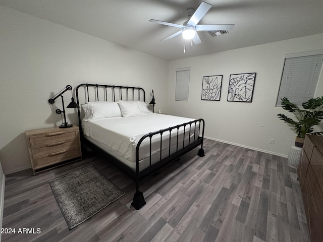 bedroom with ceiling fan and dark hardwood / wood-style floors