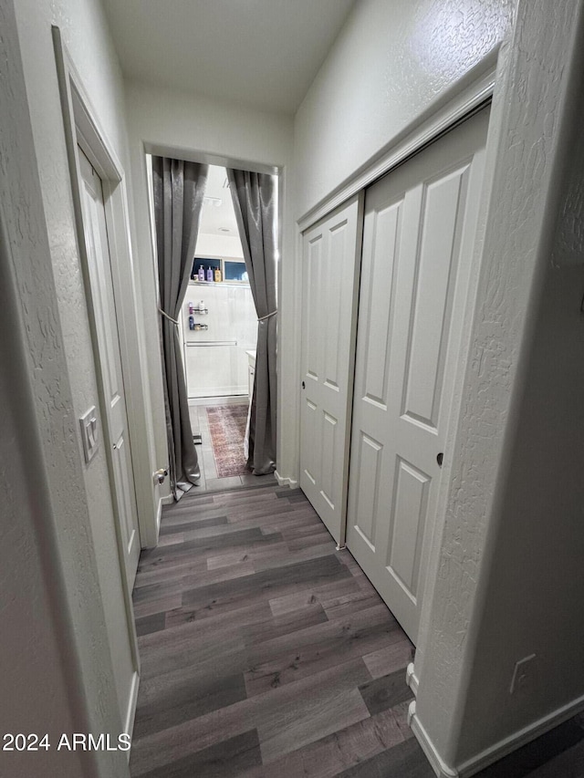 corridor featuring dark wood-type flooring