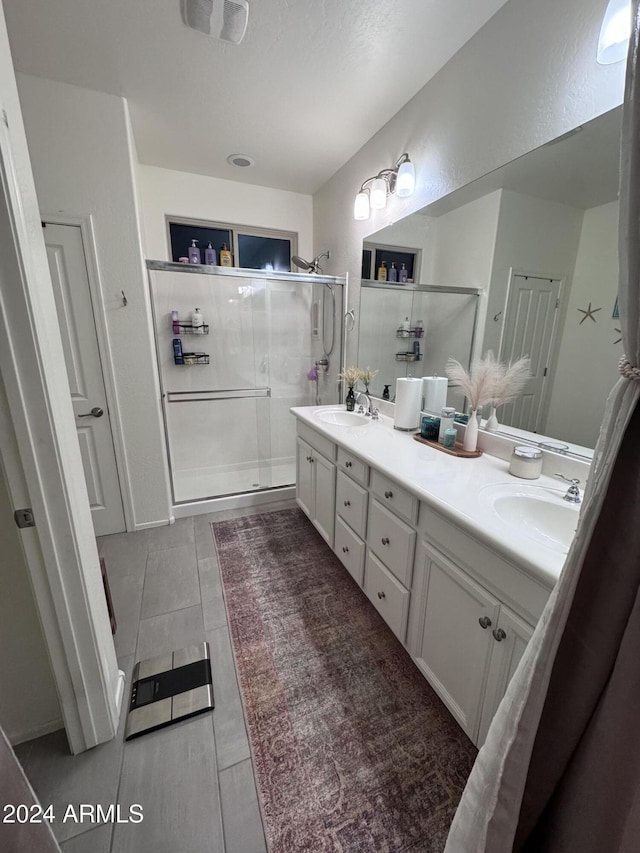 bathroom with vanity and an enclosed shower