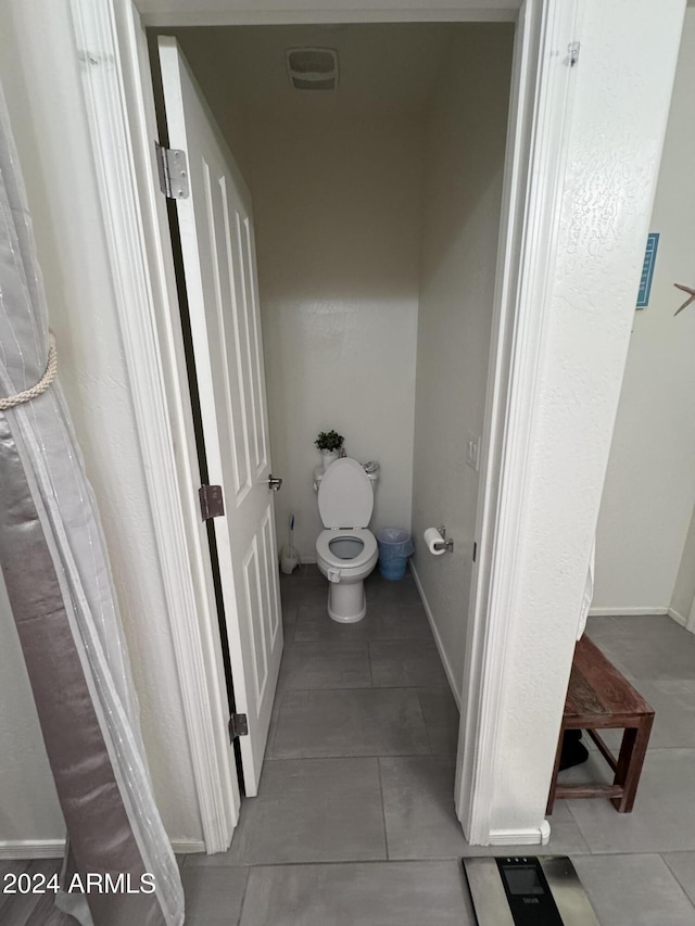 bathroom featuring tile patterned flooring and toilet