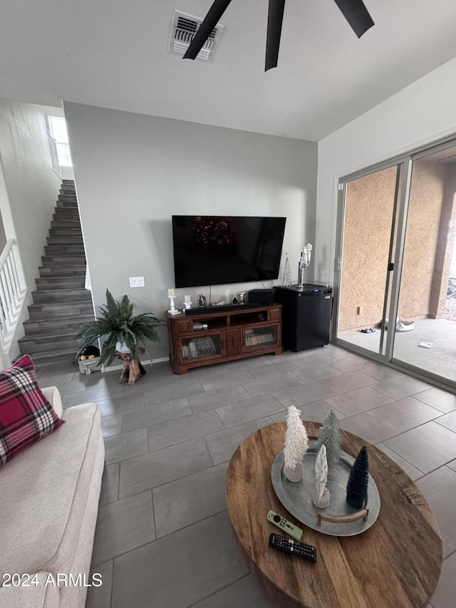 living room featuring tile patterned floors and ceiling fan