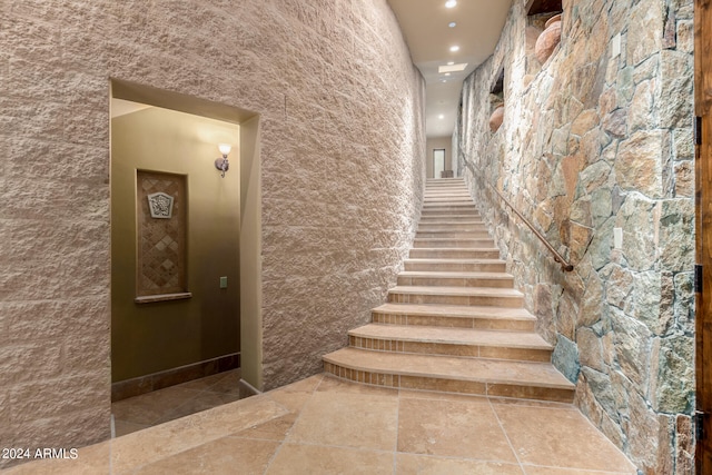 stairway featuring light tile floors