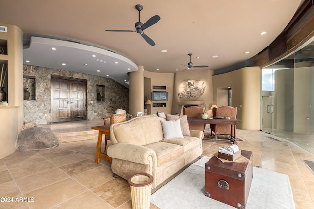 living room with light tile flooring and ceiling fan