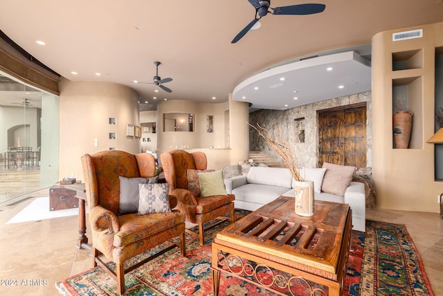 tiled living room with ceiling fan