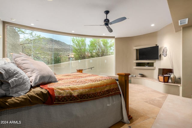 tiled bedroom with multiple windows and ceiling fan