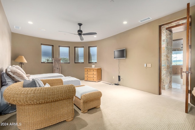 bedroom featuring light carpet and ceiling fan