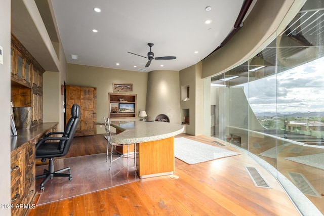 office space with dark hardwood / wood-style floors and ceiling fan