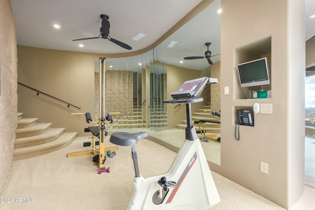 exercise area featuring light carpet and ceiling fan