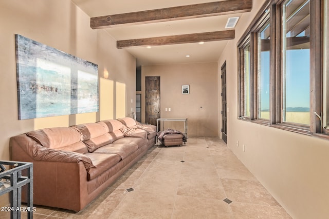 living room featuring light tile floors and beam ceiling