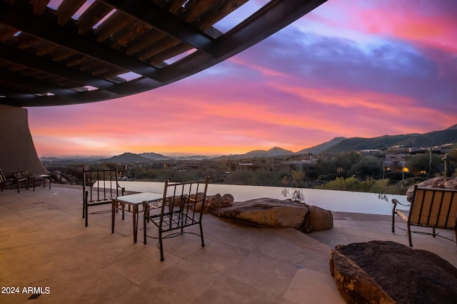 patio terrace at dusk with a mountain view