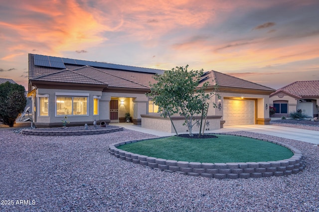 view of front of home with a garage and solar panels