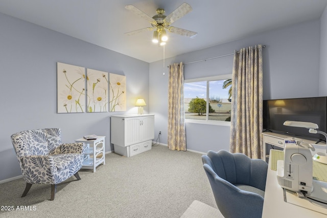 home office featuring light carpet and ceiling fan