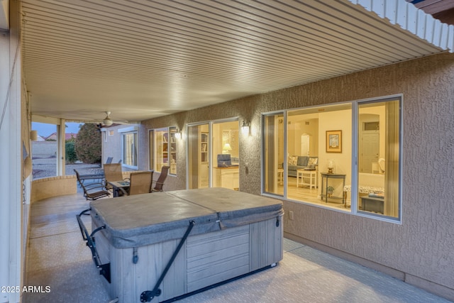 view of patio / terrace with a hot tub and ceiling fan