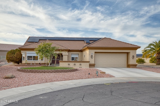 view of front of house featuring a garage and solar panels