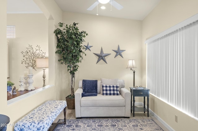 living area featuring hardwood / wood-style flooring and ceiling fan