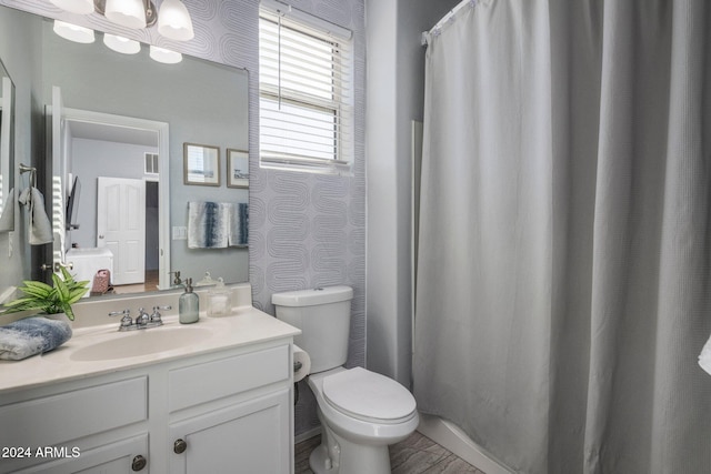 bathroom featuring toilet and vanity