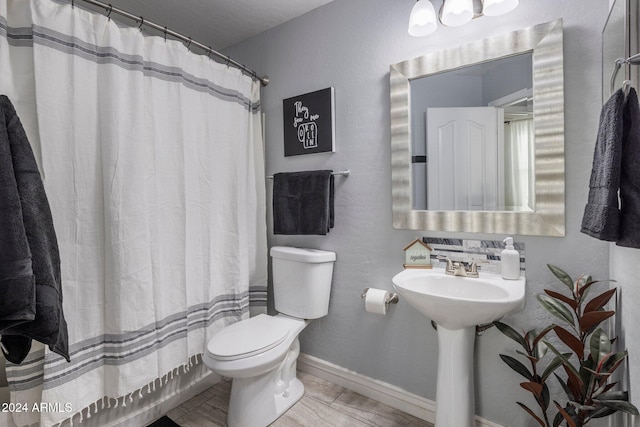 bathroom featuring toilet and a shower with curtain