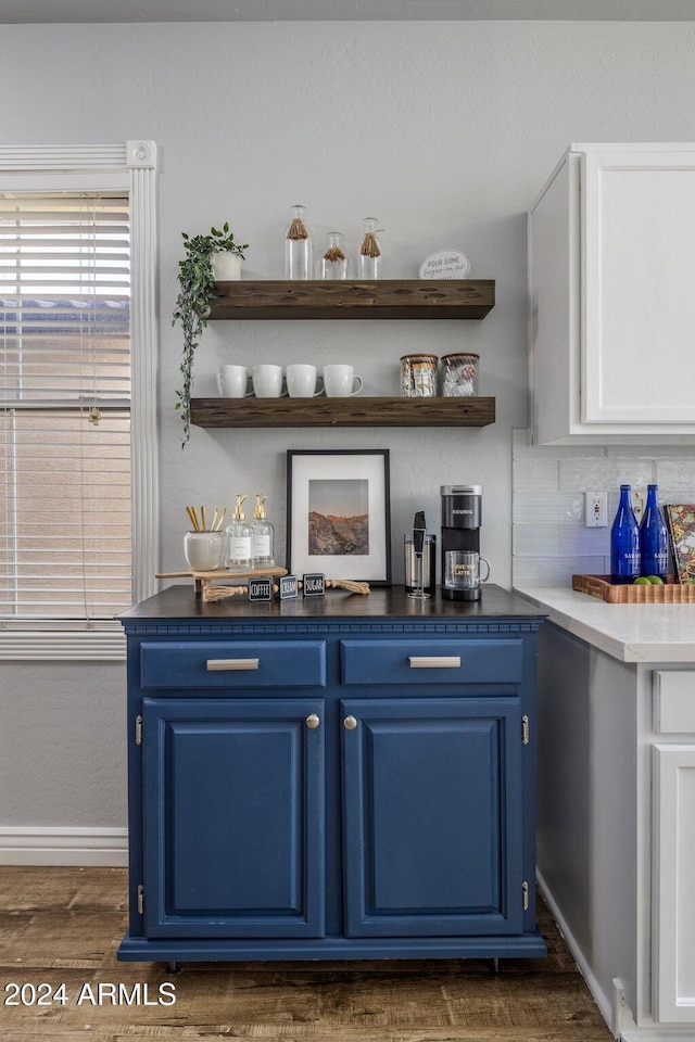 bar with blue cabinetry, white cabinets, dark hardwood / wood-style flooring, and tasteful backsplash