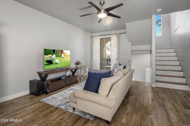 living room featuring ceiling fan, dark wood-type flooring, and a wealth of natural light