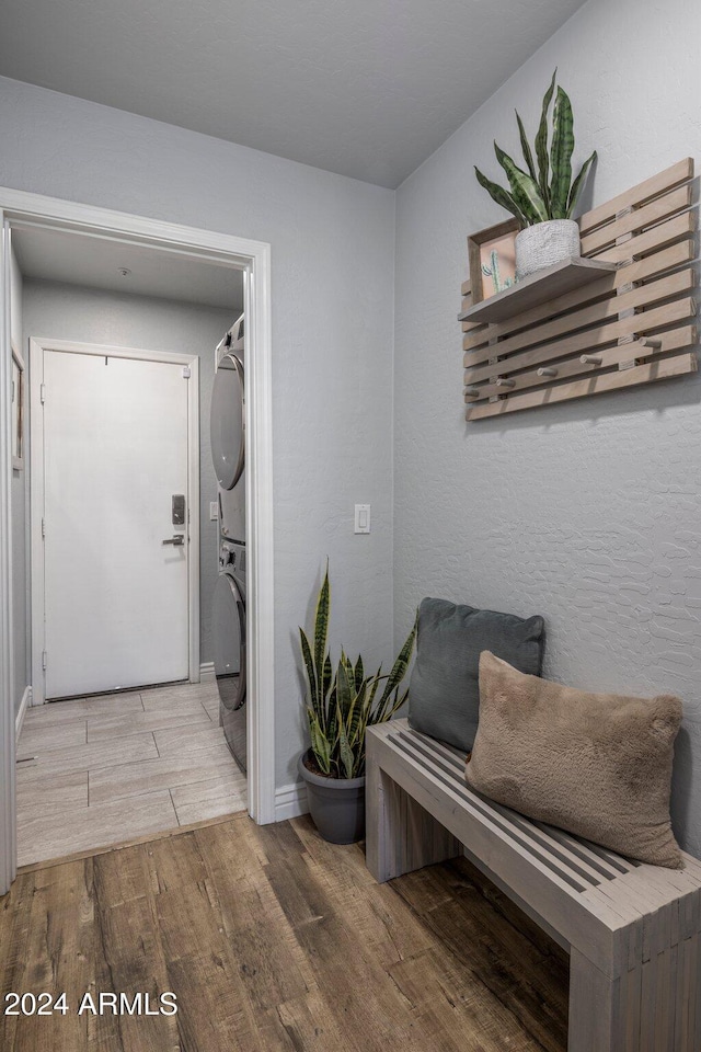 interior space featuring stacked washer and clothes dryer