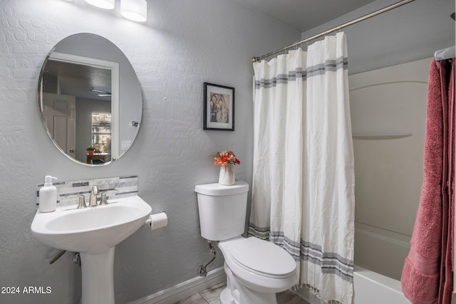 bathroom featuring toilet, shower / tub combo, and tile patterned flooring