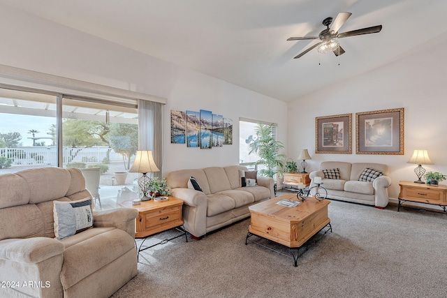 living room featuring ceiling fan, carpet floors, and lofted ceiling