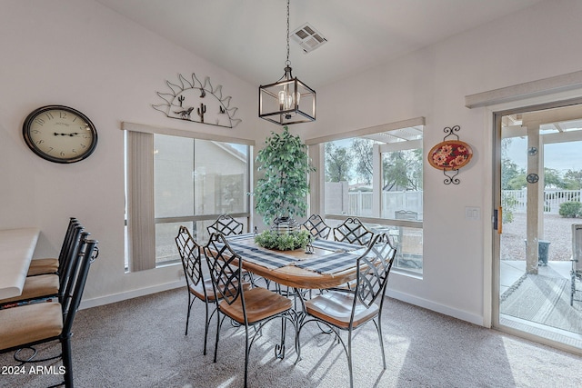 carpeted dining space featuring plenty of natural light