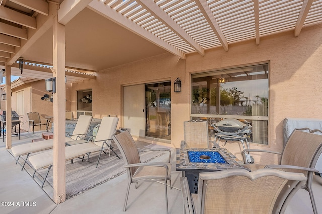 view of patio / terrace with a pergola and an outdoor fire pit