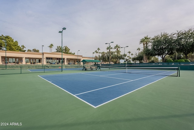 view of tennis court with basketball hoop