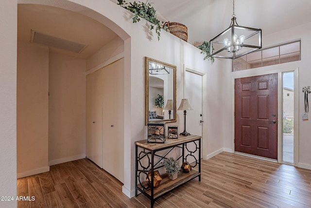 entrance foyer with a chandelier and hardwood / wood-style flooring