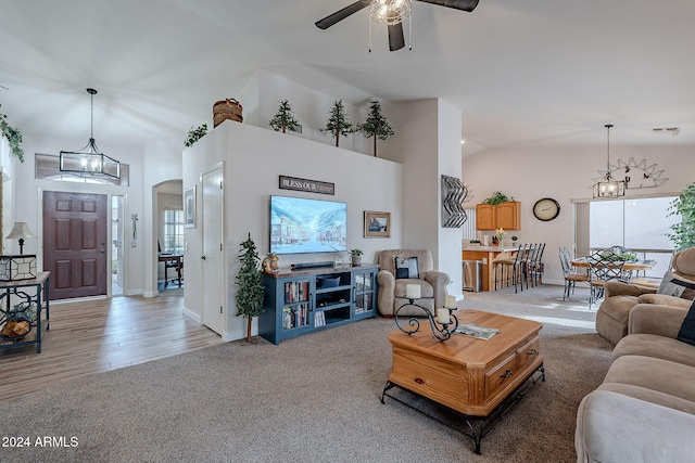 living room with light wood-type flooring, high vaulted ceiling, and ceiling fan