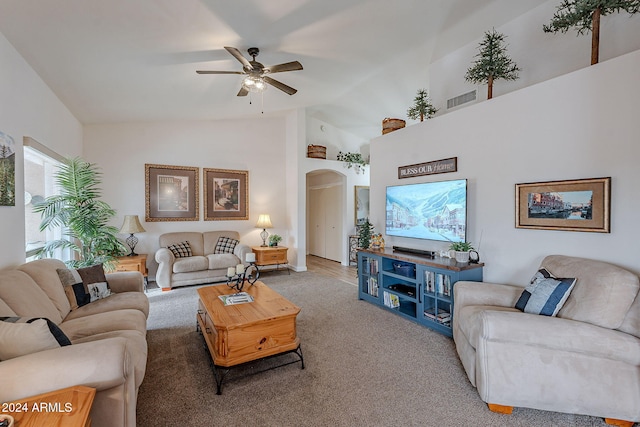 carpeted living room with high vaulted ceiling and ceiling fan