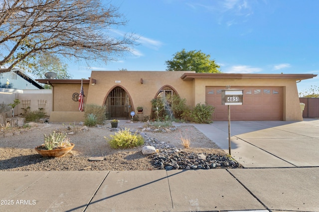 pueblo-style home with a garage