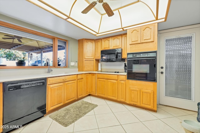 kitchen with sink, light tile patterned floors, and black appliances