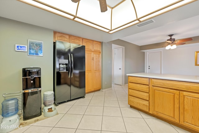 kitchen with light tile patterned floors, black refrigerator with ice dispenser, and ceiling fan