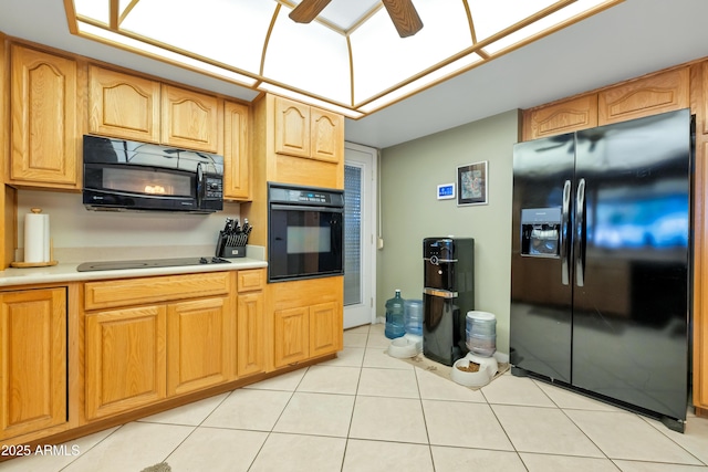 kitchen featuring black appliances, ceiling fan, and light tile patterned flooring