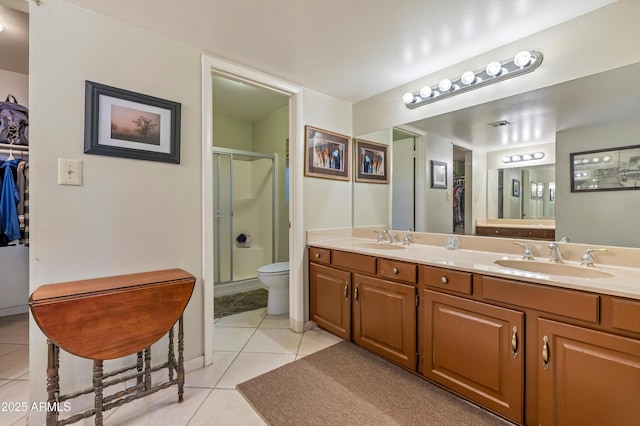 bathroom featuring walk in shower, tile patterned floors, toilet, and vanity