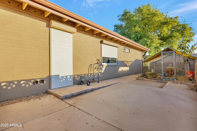 view of property exterior with a patio area