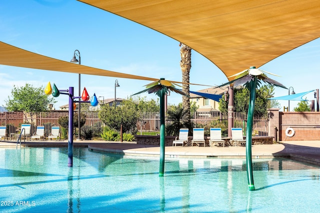 community pool featuring a patio area and fence