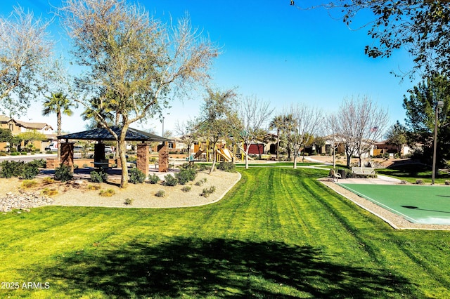 view of community with playground community, a yard, and a gazebo