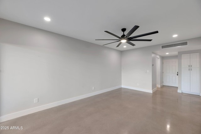 spare room featuring finished concrete flooring, recessed lighting, baseboards, and visible vents